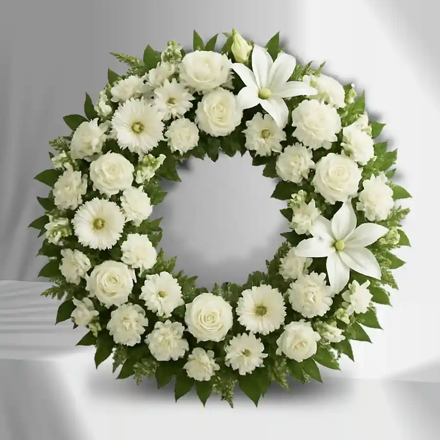 Elegant Floral Tribute Wreath made of 70 white flowers including roses, carnations, daisies, and lilies.