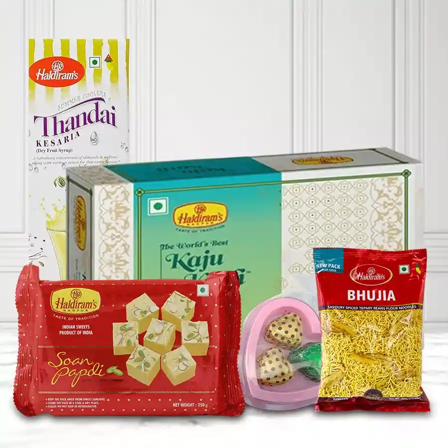 Delicious Haldirams Gift Combo featuring Soan Papdi, Kaju Katli, Bhujia, Thandai bottle, and homemade chocolates in a heart-shaped box
