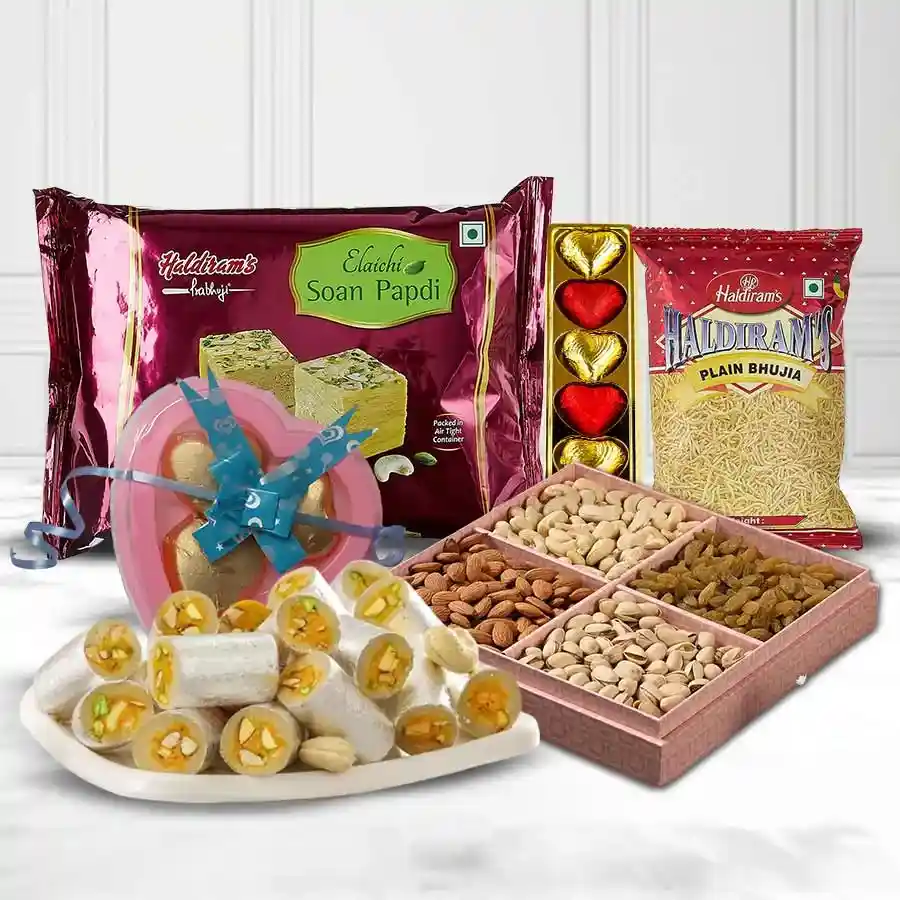 Haldirams Dollops of Dream Assortment box featuring Soan Papdi, crispy Bhujia, Kaju Pista Rolls, assorted dry fruits, homemade chocolates, and heart-shaped treats