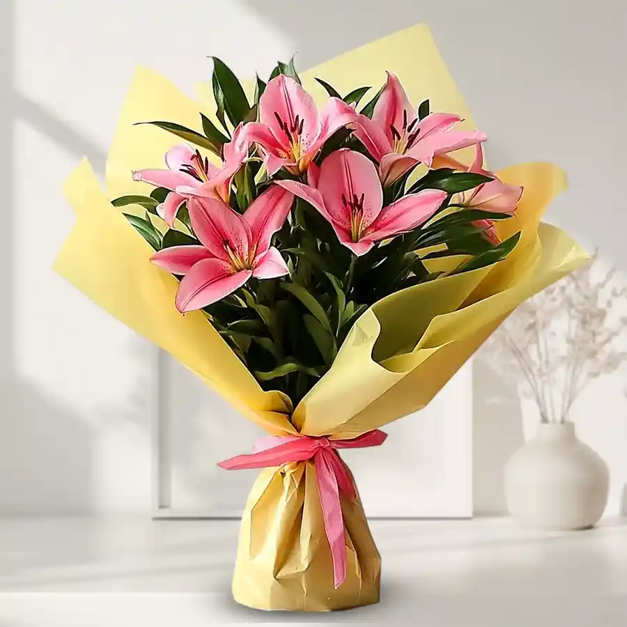 Vibrant bouquet of five pink lilies designed to welcome a new bride.