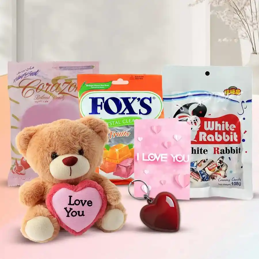 Beautiful Love Special Combo featuring a cuddly teddy with a heart, White Rabbit Milk Chocolates, Heart Shaped Corazon treats, a Heart Shaped Key Ring, an "I Love You" card, heart-shaped chocolates, and a playful fox.