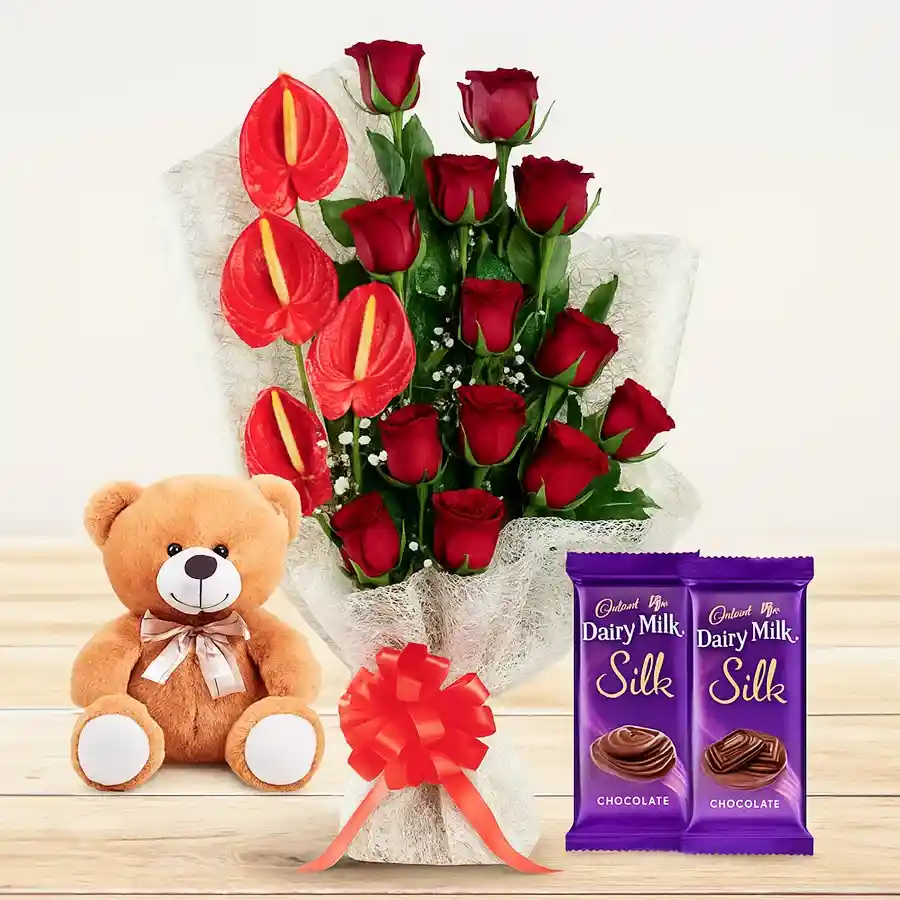 Heartfelt gift of red roses, teddy bear, and chocolates.