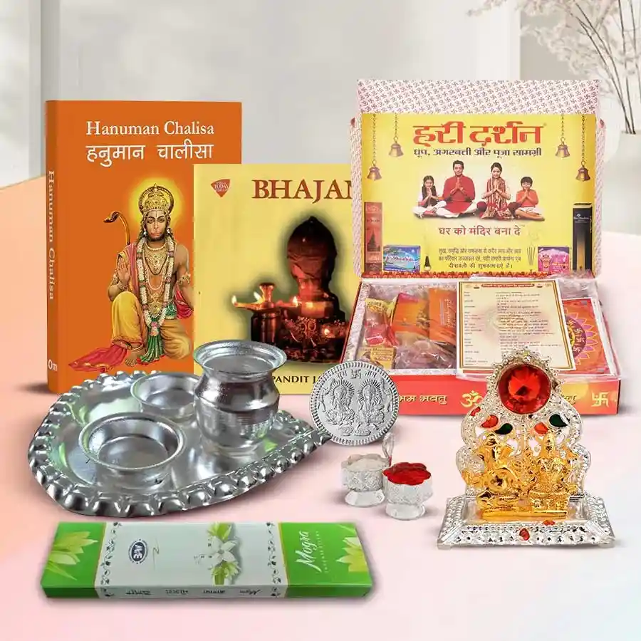 Marvelous Puja Gift Hamper including Ganesh Lakshmi Mandap, silver coin, Pan Thali, Hanuman Chalisa Book, Bhajan Music CD, Agarbati Packet, Roli-Tika, and Puja Samagri