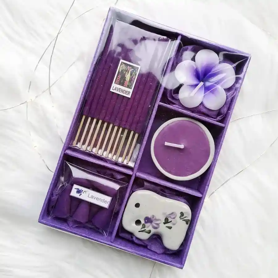 A beautifully arranged assortment of aromatic candles and incense sticks in a decorative package, evoking a sense of joy and serenity.