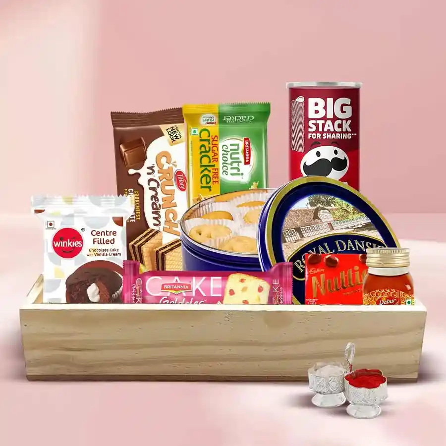 Dainty Snacks Chest filled with a variety of delicious treats including cakes, chocolates, crackers, and honey in a decorative gift container