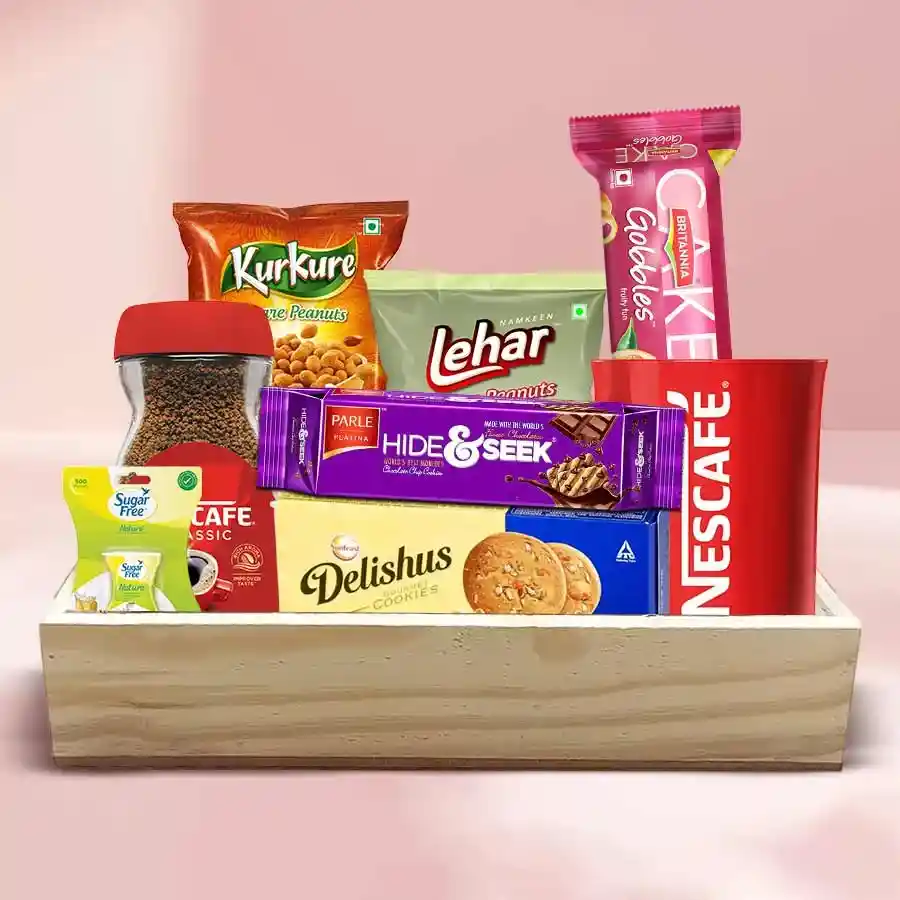 Ecstatic Goodies Tray filled with Britannia Hide & Seek Biscuits, Fruit Cake, Little Hearts, ITC Delishus Biscuits, Kurkure, Lehar Peanuts, Nescafé Coffee Jar, and a stylish sugar-free coffee mug