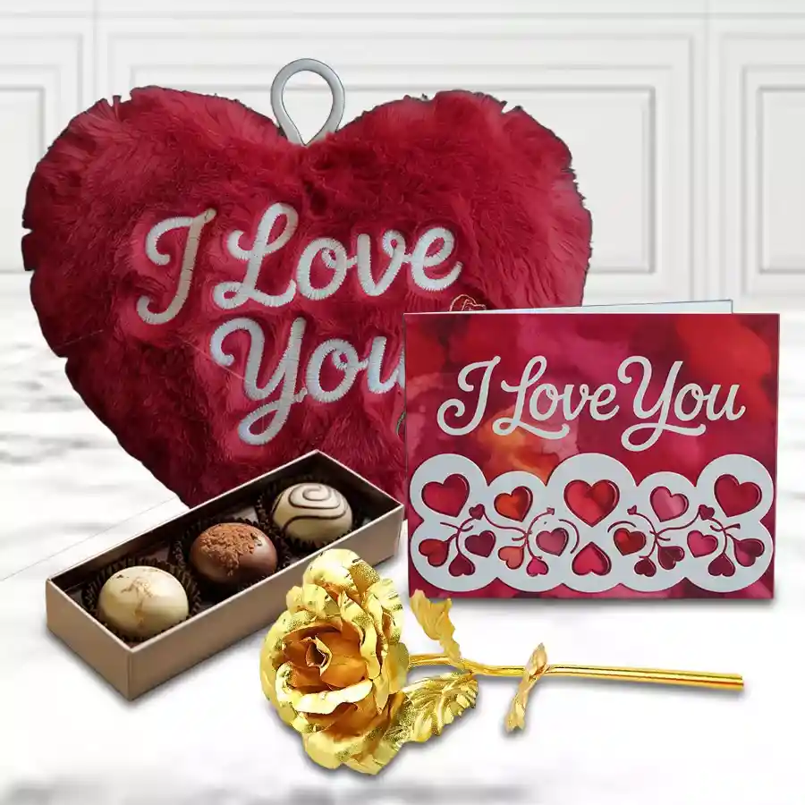 Beautiful combo gift for anniversary featuring an Anniversary Message Card, a golden rose, a heart-shaped cushion, and handmade chocolates arranged in a decorative hamper.