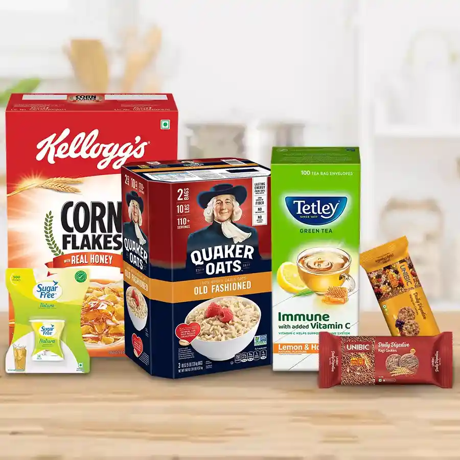 Exclusive Food Gift Hamper featuring Kellogg's Cornflakes, Quaker Oats, Organic India Green Tea, Sugarfree Pallets, UNBIC Multigrain Biscuits, and Ragi Digestive Biscuits