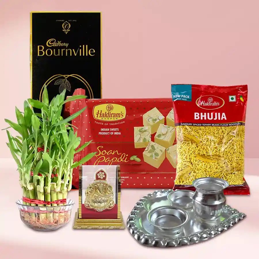 Eco-Friendly Good Luck Gift Hamper featuring a Lucky Bamboo plant, Vighnesh Ganesh idol, silver-plated paan-shaped pooja thali, Haldiram’s Soan Papdi, Bhujia, and Cadbury Dark Milk chocolate.
