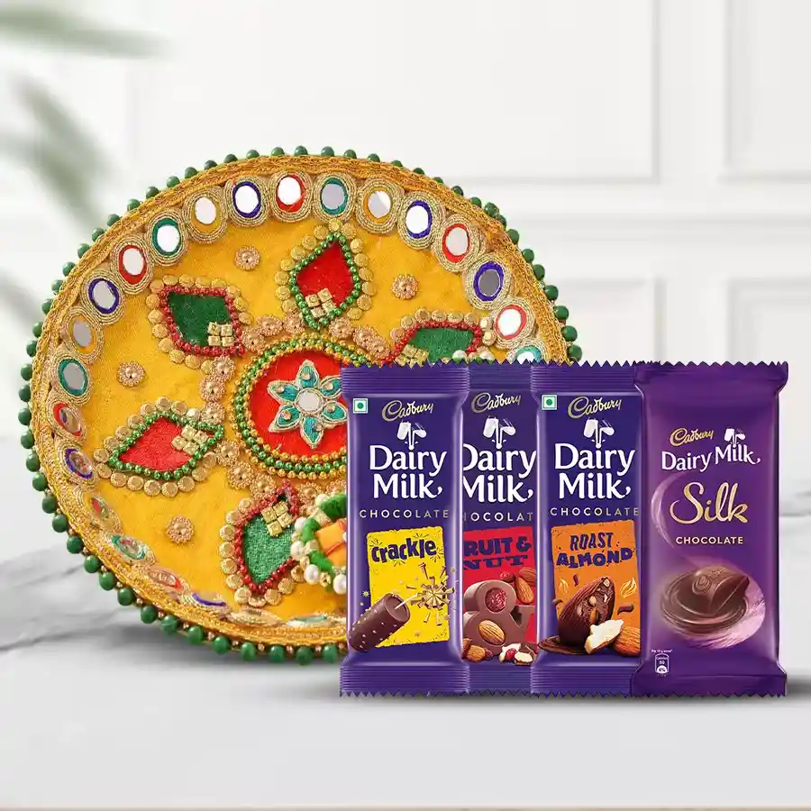 Assorted Cadbury chocolates including Fruit & Nut, Crackle, Roast Almond, Cadbury Silk, and a beautifully designed Pooja Thali in a gift package