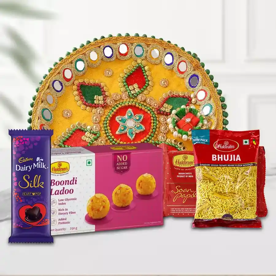 Haldirams Assortment Cadbury Chocolate and Pooja Thali featuring Boondi Ladoo, Soan Papdi, Bhujia, and Cadbury Silk Heart Pop Out.