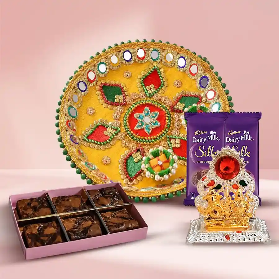 Brownie N Gifts set featuring a Designer Pooja Thali, two Cadbury Silk bars, six dry brownies, and a Ganesh Laxmi Mandap.