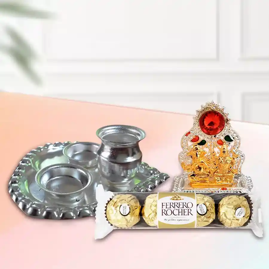 Gift hamper featuring a silver-plated paan-shaped arta thali, a Ganesh-Laxmi mandap, and four Ferrero Rocher chocolates, arranged beautifully