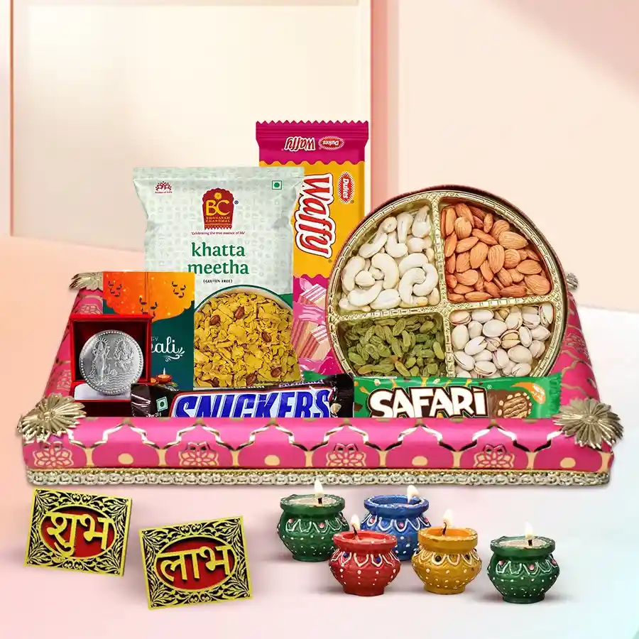 Exclusive Diwali Special Gift Hamper featuring tasty treats, dry fruits, stylish diyas, a Subh Labh wall sticker, a Diwali card, a silver-plated Laxmi Ganesh coin, and a decorated tray.