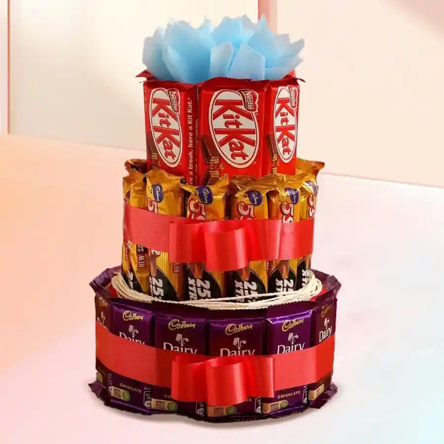 Three-tiered chocolate arrangement featuring Cadbury Dairy Milk bars, Cadbury Five Stars, and Nestle KitKats, beautifully presented for Christmas gifting.