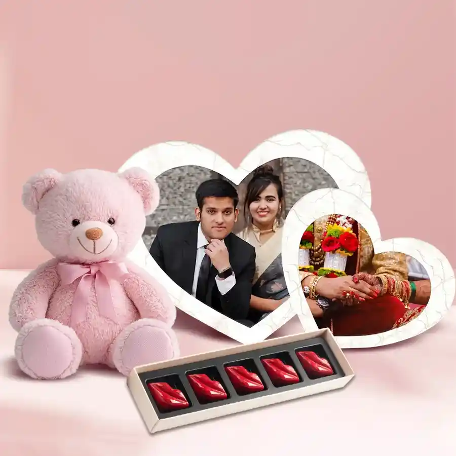 Personalized twin heart photo frame with lip-shaped chocolates and a cuddly teddy bear for Valentine's Day gift.