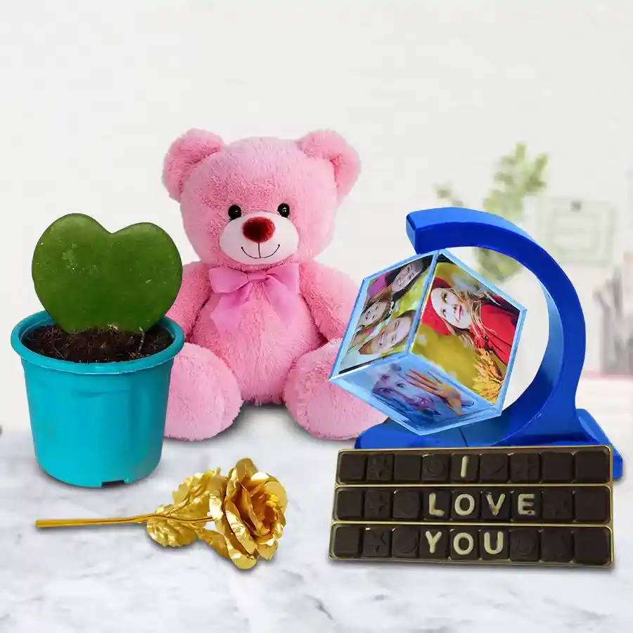 Alluring Personalized Anniversary Gift Combo featuring a custom Photo Magnetic Revolving Stand, handmade chocolates, Sweetheart Plant, Golden Rose, and a 6-inch Teddy bear.