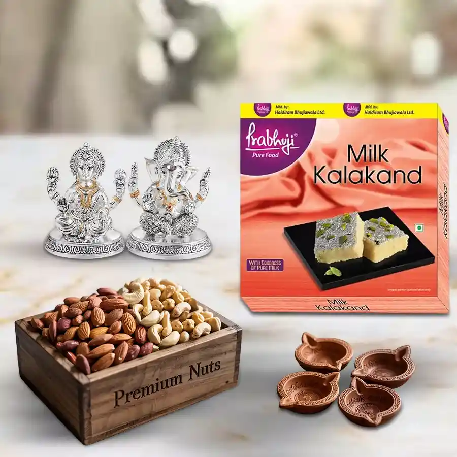 Haldiram sweets and dry fruits combo with terracotta diyas and a Lakshmi Ganesh idol in a wooden box