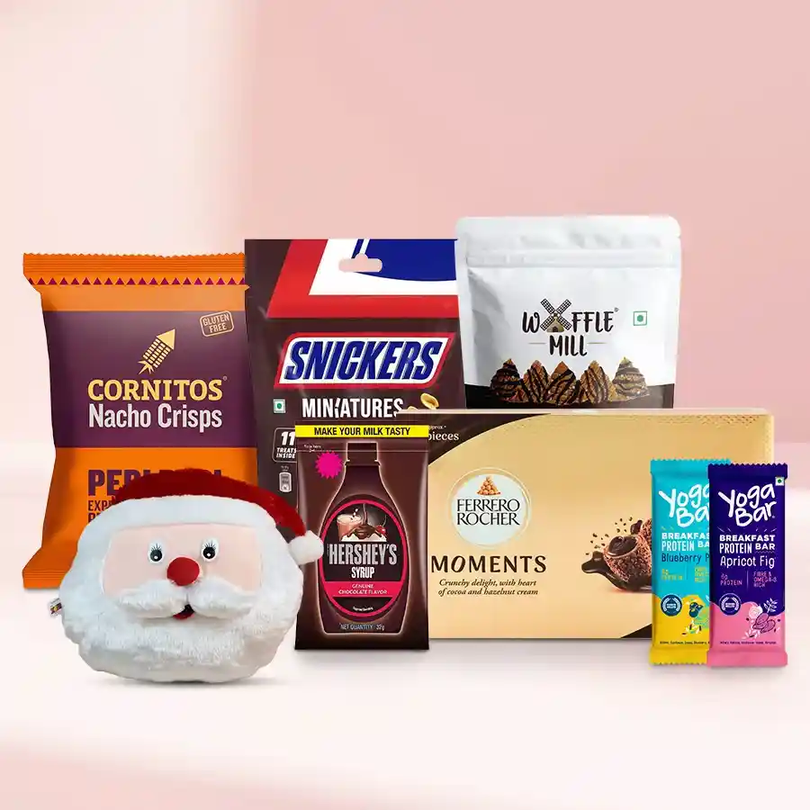 Magical Santa cushion surrounded by chocolates and festive treats