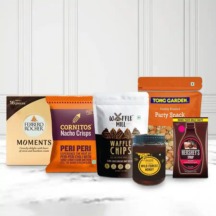 Unique Collection Gourmet Hamper featuring Waffle Chocolate Chips, Cornitos Nachos, Tong Garden Party Mix, Avasa Organic Honey, Hershey’s Chocolate Syrup, and Ferrero Moments, all beautifully arranged for Christmas gifting.