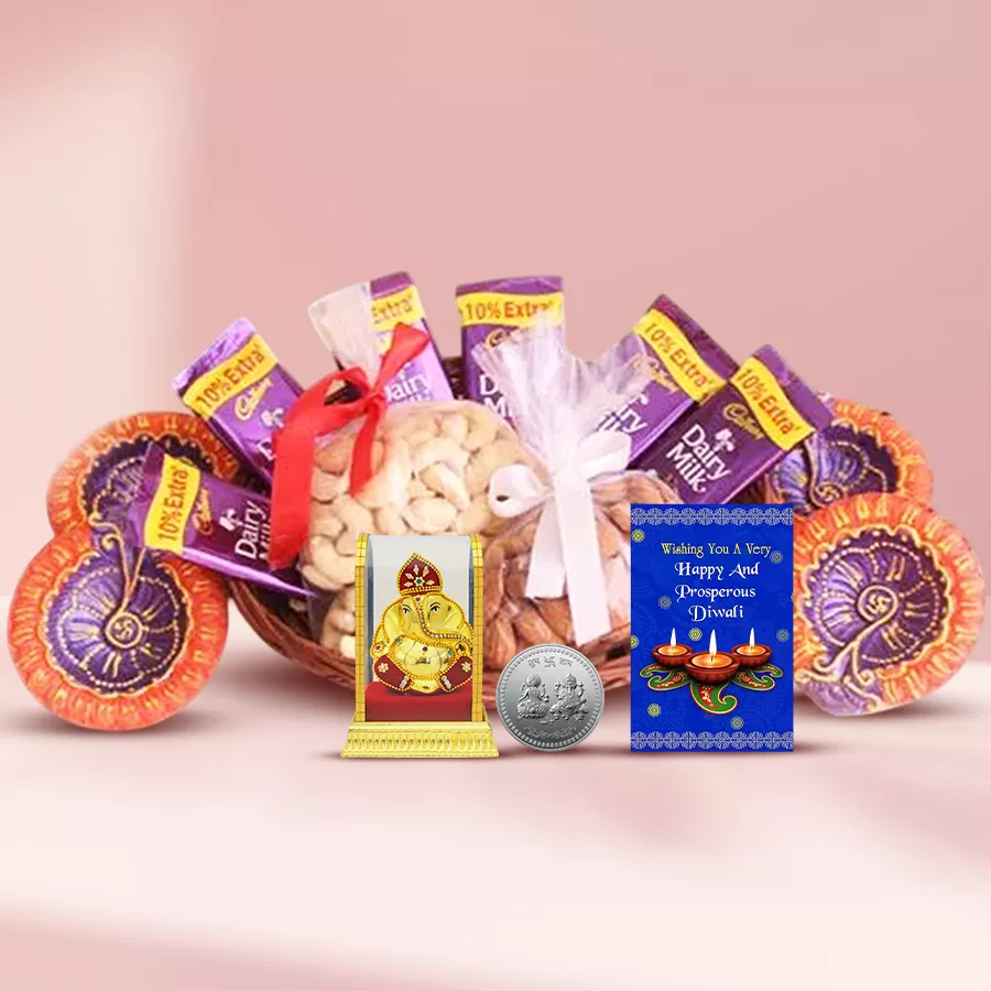 Basket of Flavours and Joy Diwali Hamper featuring premium nuts, Cadbury chocolates, decorative Diyas, a silver coin, a Vignesh Ganesh idol, and a Diwali card in a cane basket