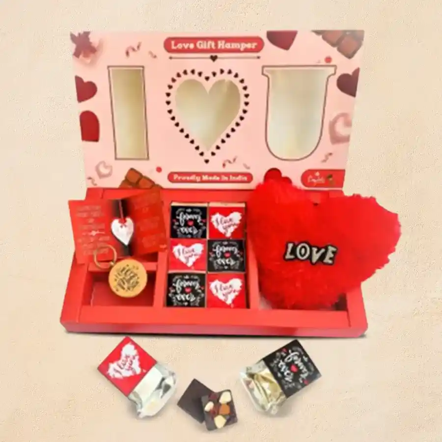Romantic hamper featuring premium chocolates, a wooden keychain, a heart-shaped pillow, and a love greetings card, all elegantly arranged in a high-quality gift box.