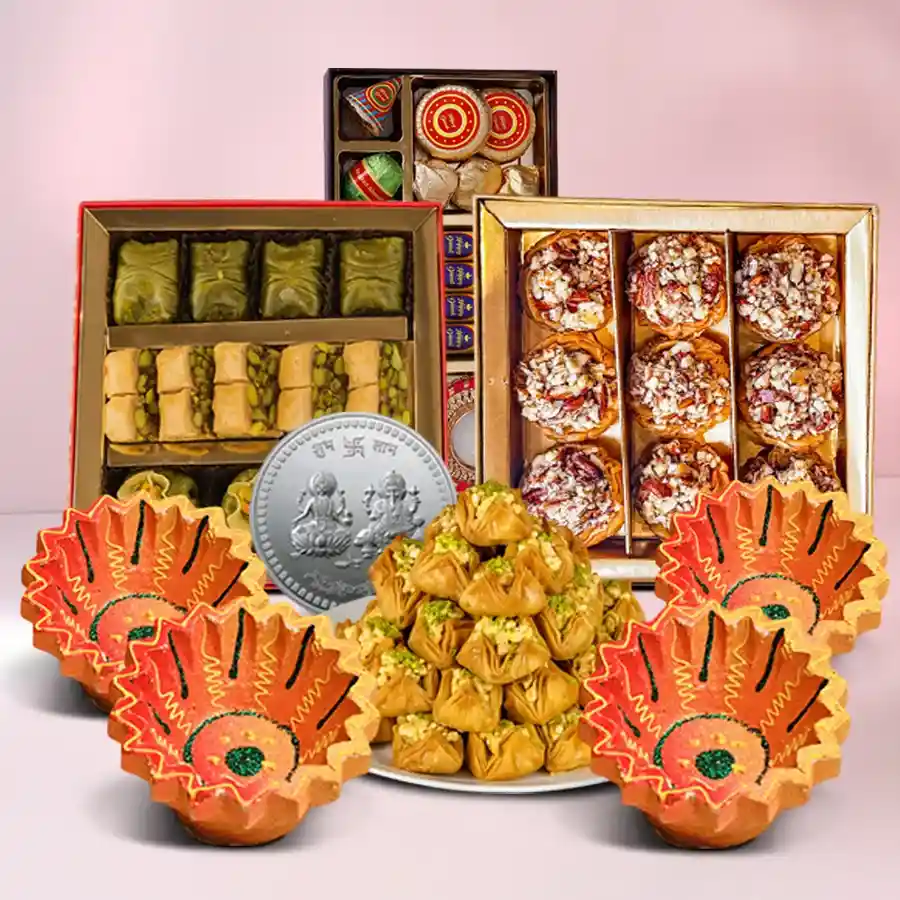 Exquisite Diwali Medley Hamper featuring Baklawa, handmade chocolates, Ganesh Lakshmi coin, and designer clay diyas on a festive background.