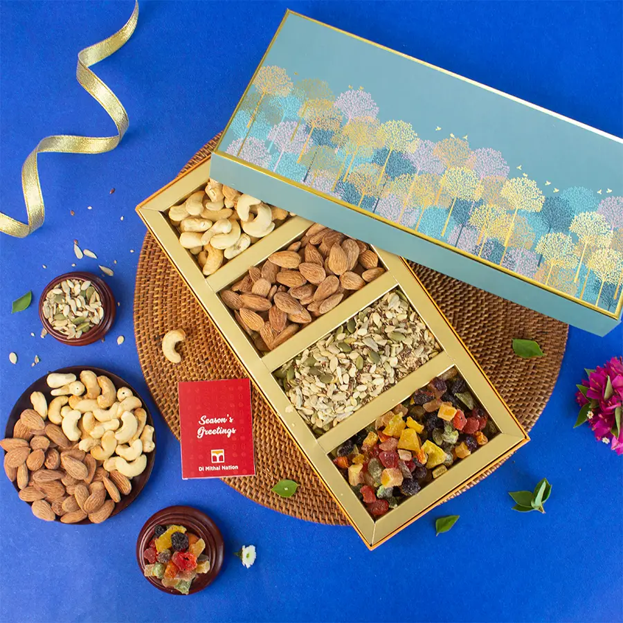 Elegant blue tree box filled with roasted almonds, cashews, a nutritious seed mix, and a vibrant berry assortment, with a festive greeting card beside it.