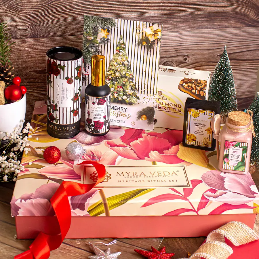 Unwind and Rejuvenate Gift Hamper featuring Almond Brittle Chocolate, 24Kt Gold Soap, organic clay, pure Rose Water, Organic Soya Wax Candle, and Turkish Rose, Almond, Saffron, and Goat Milk Lotion arranged elegantly in a decorative basket