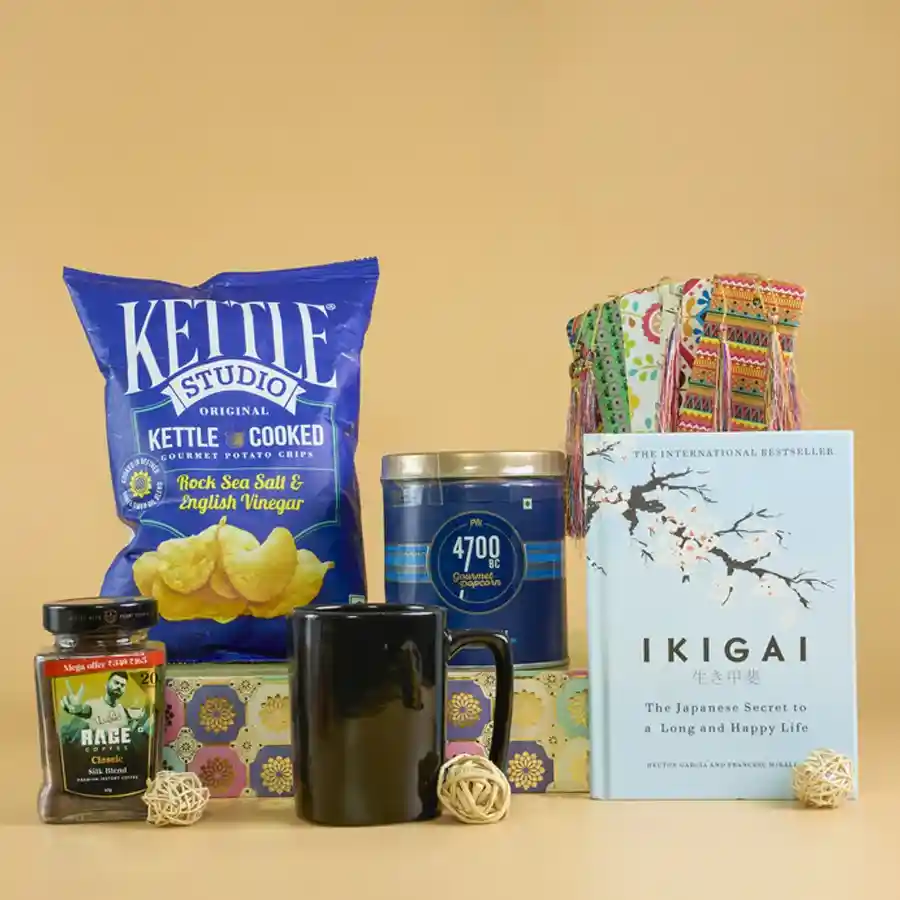 Cozy Reading and Gourmet Treats Gift Set featuring popcorn, potato chips, coffee mug, book, and a designer basket.