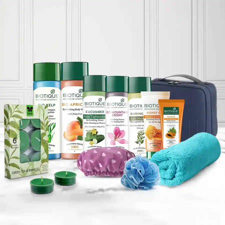 Biotique Spa Luxury Gift Set featuring body wash, face wash, toner, hair care products, scented tea lights, and a toiletry kit bag.