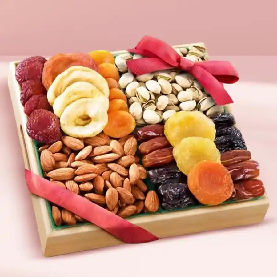 Gourmet Dry Fruits Gift Tray featuring almonds, pistachios, dried apricots, premium dates, dried strawberries, and cranberries in a wooden tray with a red ribbon.