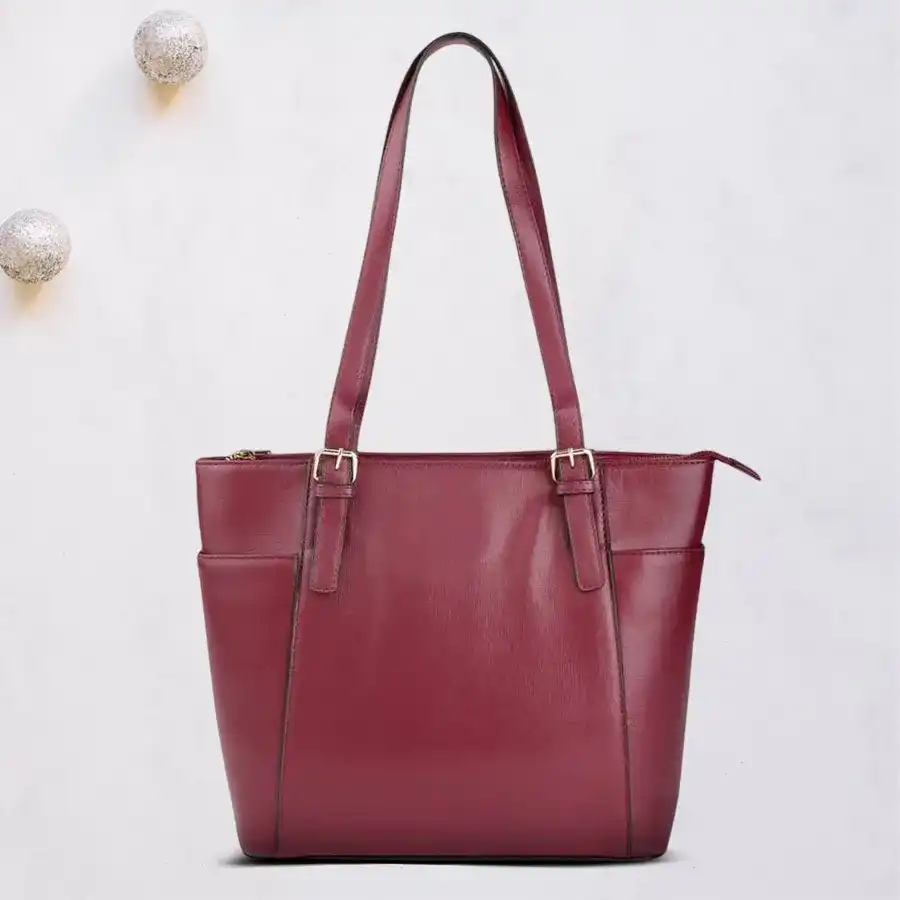 Elegant faux leather shoulder bag in dark maroon with embossed design and double zip closure. Perfect for ladies' casual or professional wear.